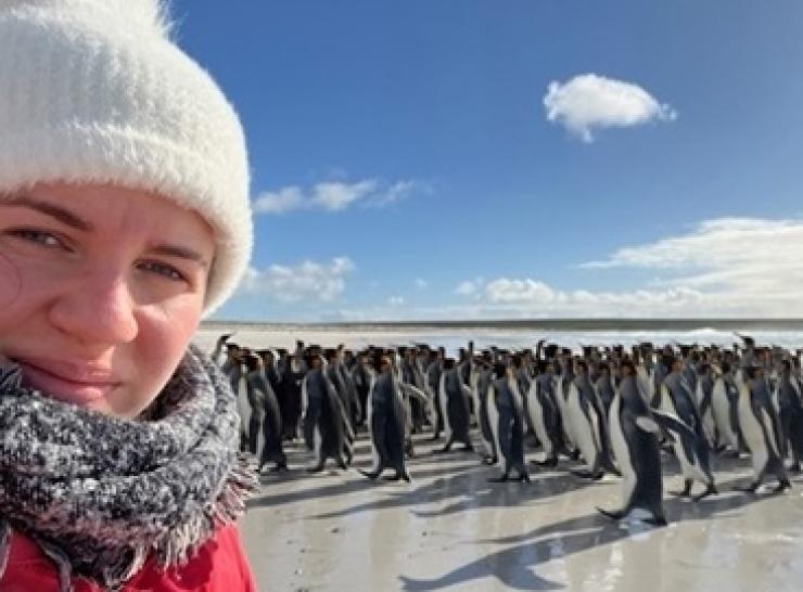 Emily Williams with King Penguins in the Falklands.