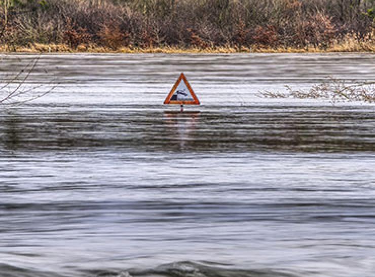 Road sign almost submerged in high water