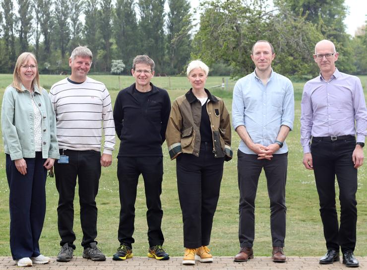 Six people standing in a row