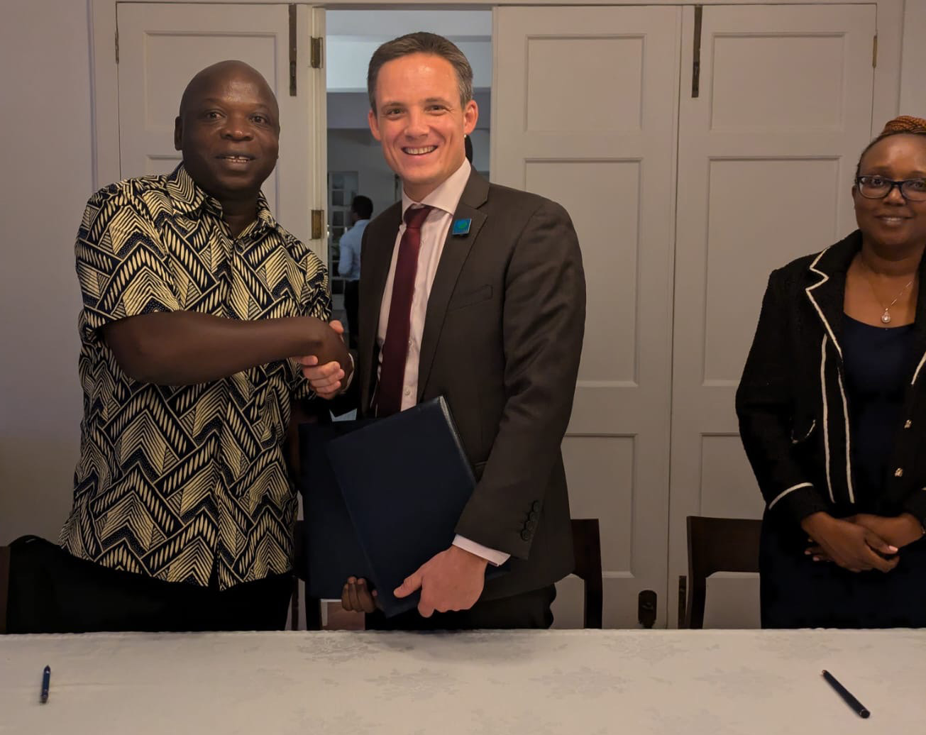 Shaking hands after signing MoU with Kenya Marine and Fisheries Research Institute