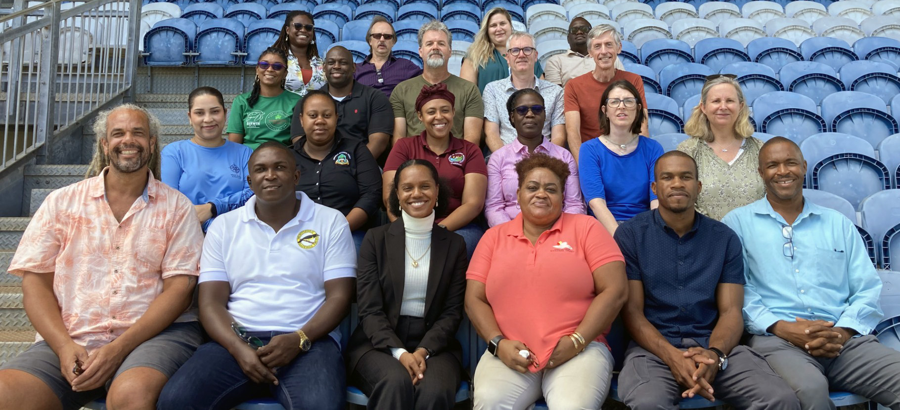 Group shot of 21 people sitting in stadium type seats