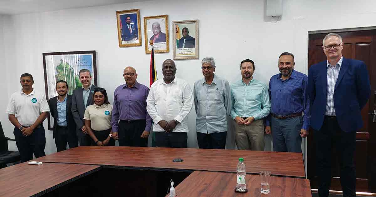 Ten people standing behind a desk