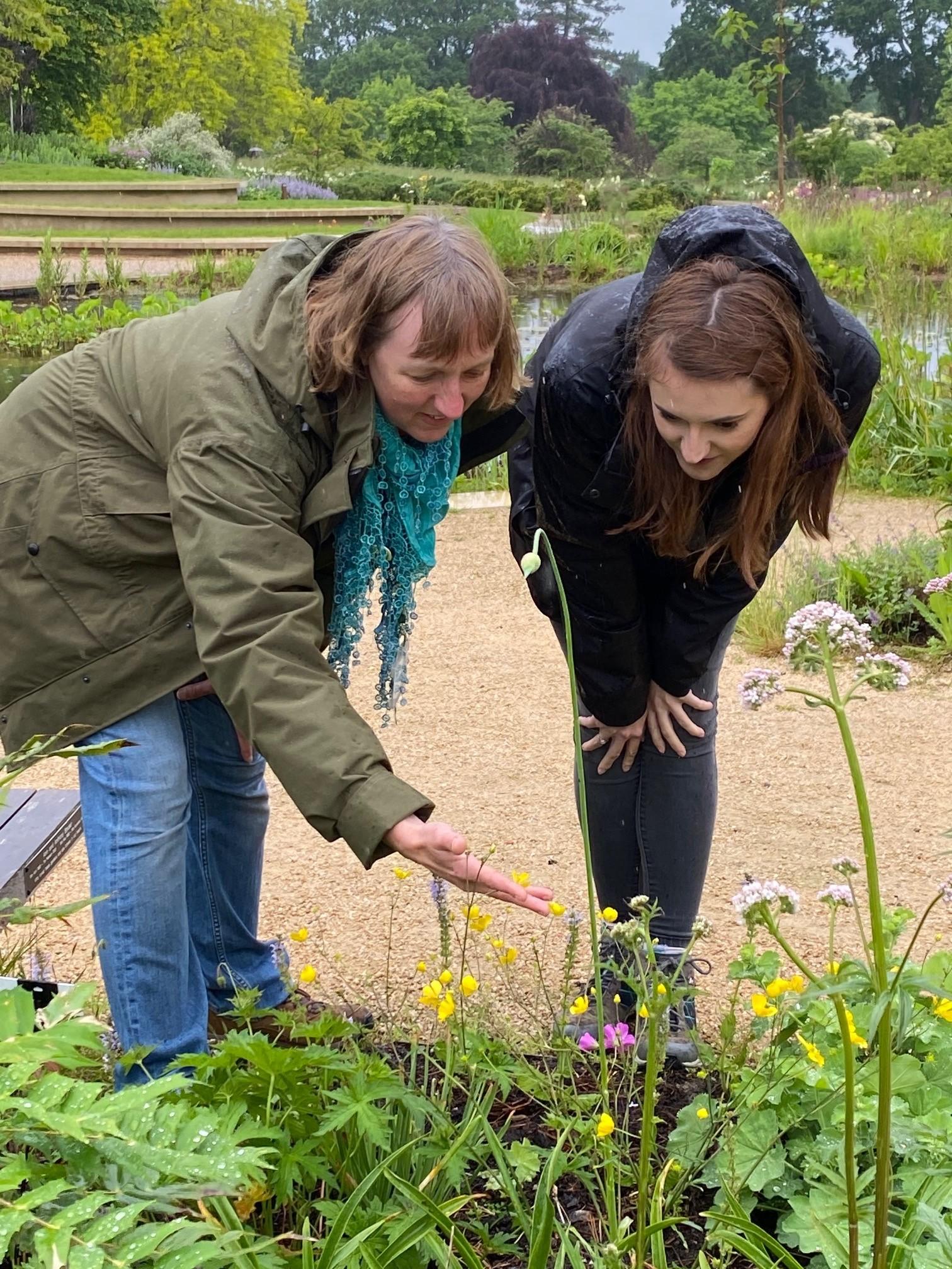 Helen Bostock (RHS) and Alice Hope (UKCEH) exploring the wildlife garden at Wisley