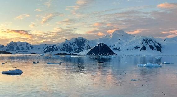 View towards sunset over ice covered hills