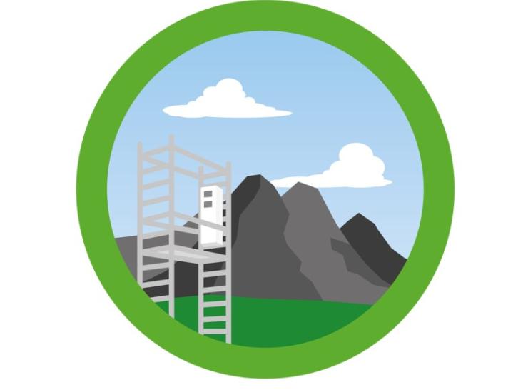 Green circle with mountains in background and monitoring station